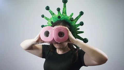 Coronavirus is watching you through a roll of toilet paper. Stock Footage 128073118