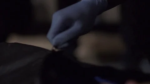 Coroner zips up a body bag Stock Footage