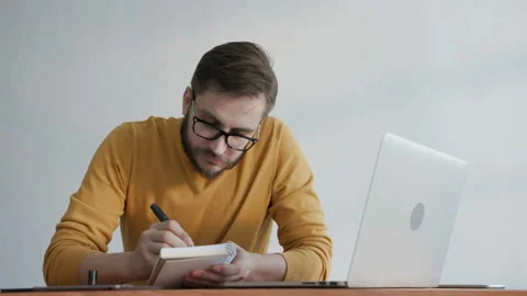 Corporate 30s employee with glasses processing information with paper for succes Stock Footage 199474796