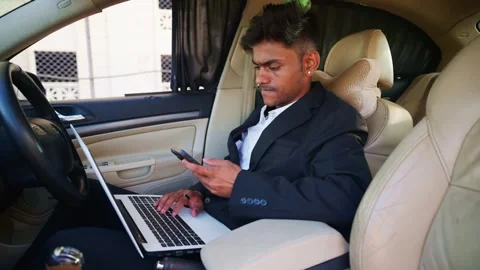 Corporate agent work on laptop while conversing in car Stock Footage 310717367
