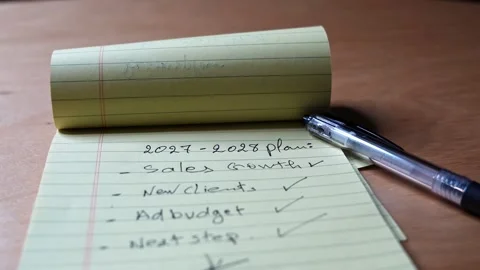 Corporate Business Strategy Plan On Yellow Notepad Stock Footage 338045841