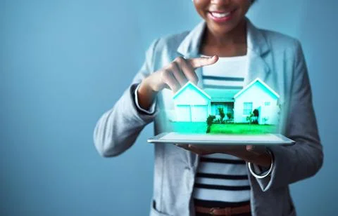 Corporate business woman holding a tablet with property cgi graphics while Stock Photos