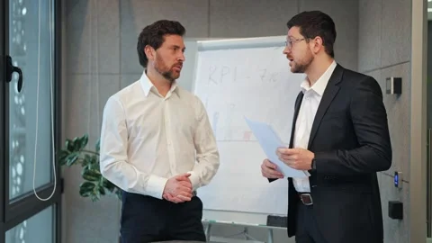Corporate Colleagues Reviewing Important Documents with Focus Stock Footage 330227128