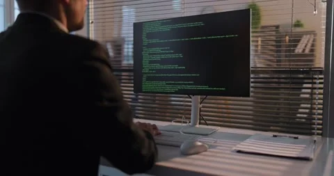 Corporate developer writing code at desktop workstation in contemporary office Stock Footage 327526875