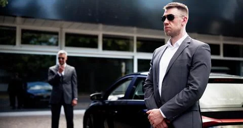 Corporate Executive Protected by Professional Security Guard Stock Photos