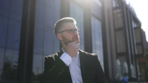 Corporate Executive in Thoughtful Pose Outside Modern Office Complex Stock Footage 330795332