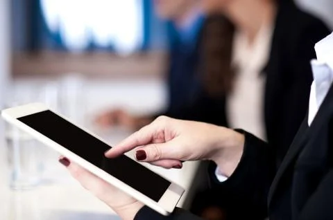 Corporate lady working on tablet device Fotos Stock
