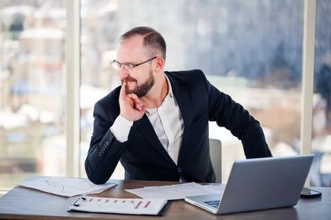The corporate madman is sitting at the computer in the office and going crazy Stock Photos