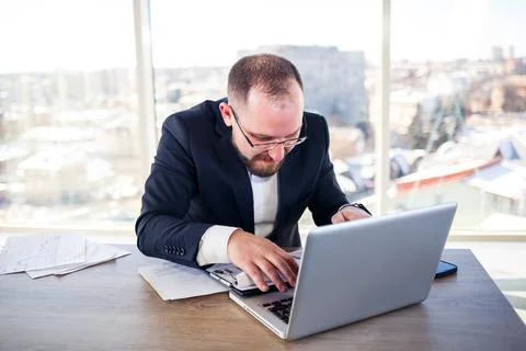 The corporate madman is sitting at the computer in the office and going crazy Stock Photos