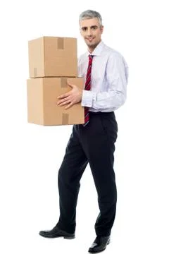 Corporate man holding stack of parcel boxes Foto stock