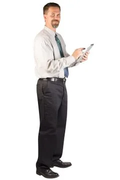 Corporate Man Standing and Using a Tablet Device Stock Photos