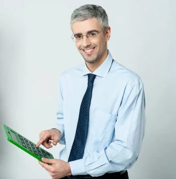 Corporate man using calculator Stock Photos