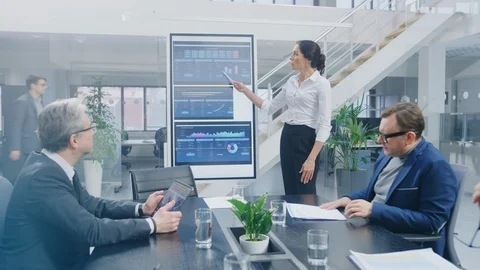 In the Corporate Meeting Room Female Analyst Uses Digital Interactive Whiteboard Stock Footage