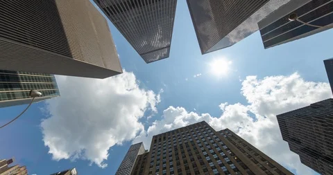 Corporate office buildings low angle rotate blue sky sunlight sun timelapse Stock Footage 113045963