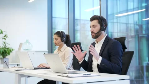 Corporate operators working with headsets in customer support service  Stock Footage 298998091