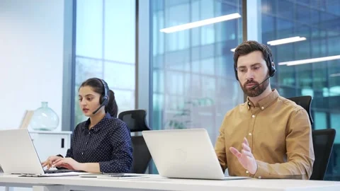 Corporate operators working with headsets in customer support service on help Stock Footage 309011639