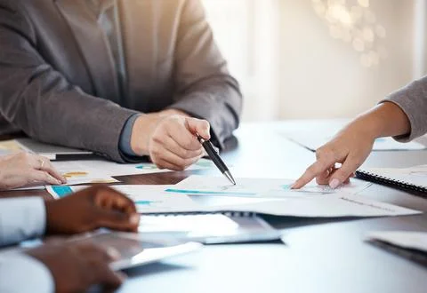 Corporate table, documents and hands in conversation on business analytics data Stock Photos