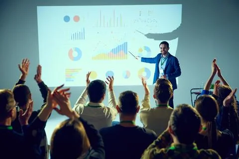 Corporate training lecture surrounded by data visualizations where man ending Stock Photos