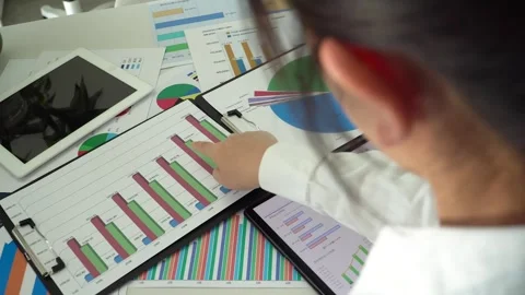 Corporate white-collar workers analyzing company financial report data chart Stock Footage 313778560