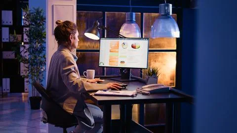 Corporate worker typing data on online report 库存照片