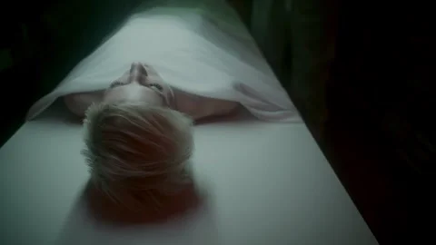 A corpse of a blond woman on the table Stock Footage 259833110