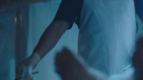 Corpse on the table and a mortician Stock Footage 283144616