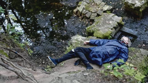 Corpse of young man in forest. Stock. Young man died as result of fall from Stock Footage 276909505
