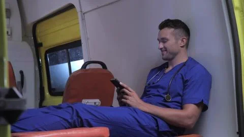 Corpsman sit on strecher in ambulance car. Stock Photos