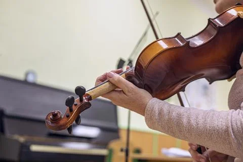 Correct hand positioning when holding a bow and violin by a teacher Stock Photos