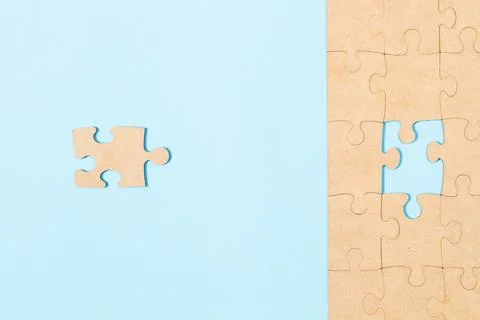 The correct missing puzzle piece on a light blue background in a top view Stock Photos