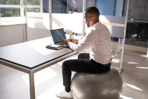 Correct Posture At Desk In Office Stock Photos