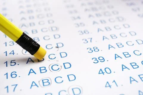 Correcting mistake with pencil eraser in answer sheet, closeup Stock Photos