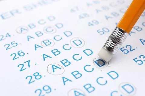 Correcting mistake with pencil eraser in answer sheet, closeup Stock Photos