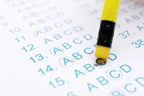 Correcting mistake with pencil eraser in answer sheet, closeup Stock Photos