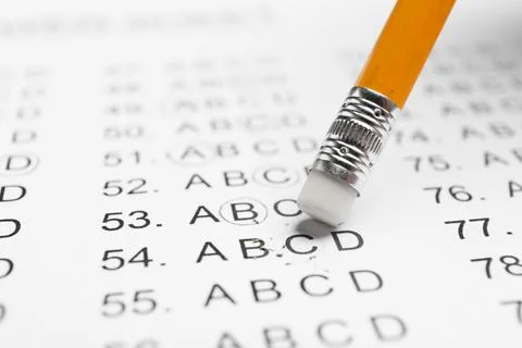 Correcting mistake with pencil eraser in answer sheet, closeup Stock Photos