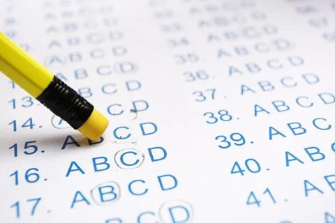 Correcting mistake with pencil eraser in answer sheet, closeup Stock Photos