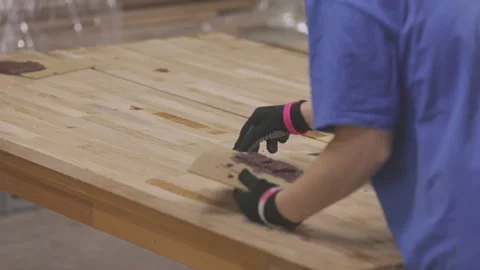 Correction of defects in a wooden board. Covering irregularities on a wooden Stock Footage 274573598