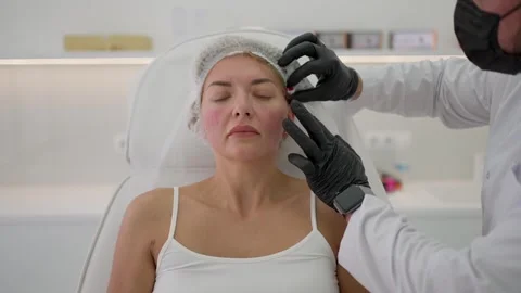 Correction of the face with the help of threads Stock Footage 243635530