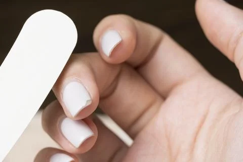 Correction of gel polish. Cut down the old varnish. Remove nail polish. Manic Stock Photos