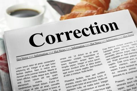 Correction newspaper layout on a breakfast table with a blurry cup of coffe.. Stock Photos