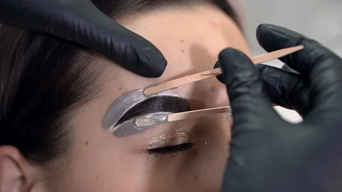 Correction of a shape of eyebrows with hot wax Stockbeeldmateriaal 146531806