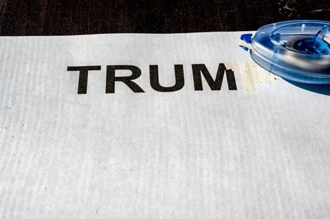 Correction tape being used to white out a paper with letters Stock Photos