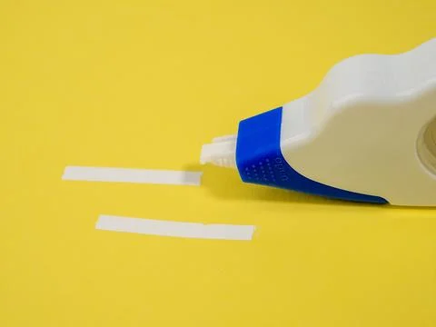 Correction tape on a yellow background. Correction roller. Stock Photos