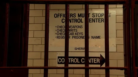 Correctional facility rules and regulations with cell bars in foreground. Video stock 106533354