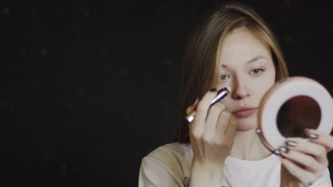 Corrector makeup. Girl doing makeup. She tones her face. 4k Stock Footage 88873429