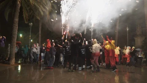 Correfoc devils burning fireworks with the crowd running straight in to the fire Stock Footage 100387714