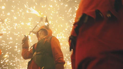 Correfoc. Excited red devil figures dancing under fireworks. Catalan fire run Stock Footage 179375780