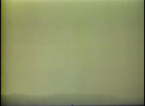 CORREGIDOR - 1945: Approach - Low green hills lie beyond flat water 库存影片 343931316