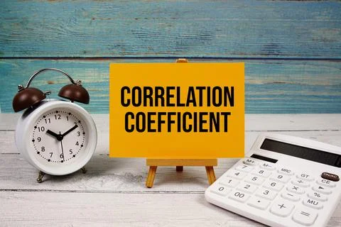 Correlation Coefficient text written on paper card with calculator and alar.. Fotos de archivo