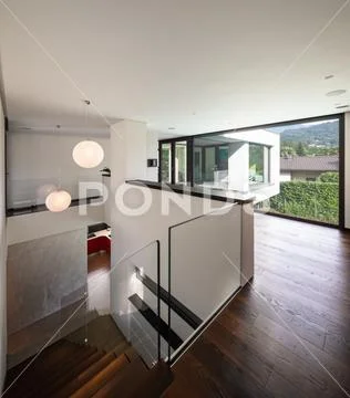 Corridor and staircase in wood with large window in modern villa Stock Photos